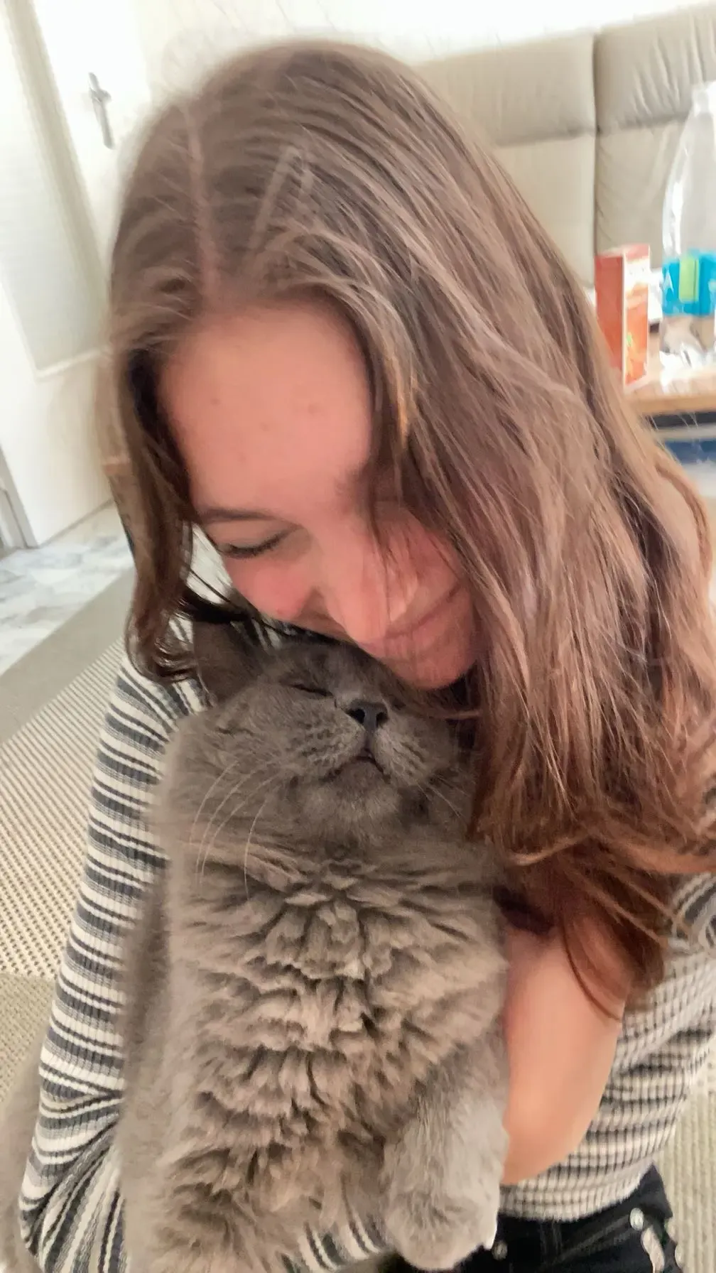Emily hugging a cat
