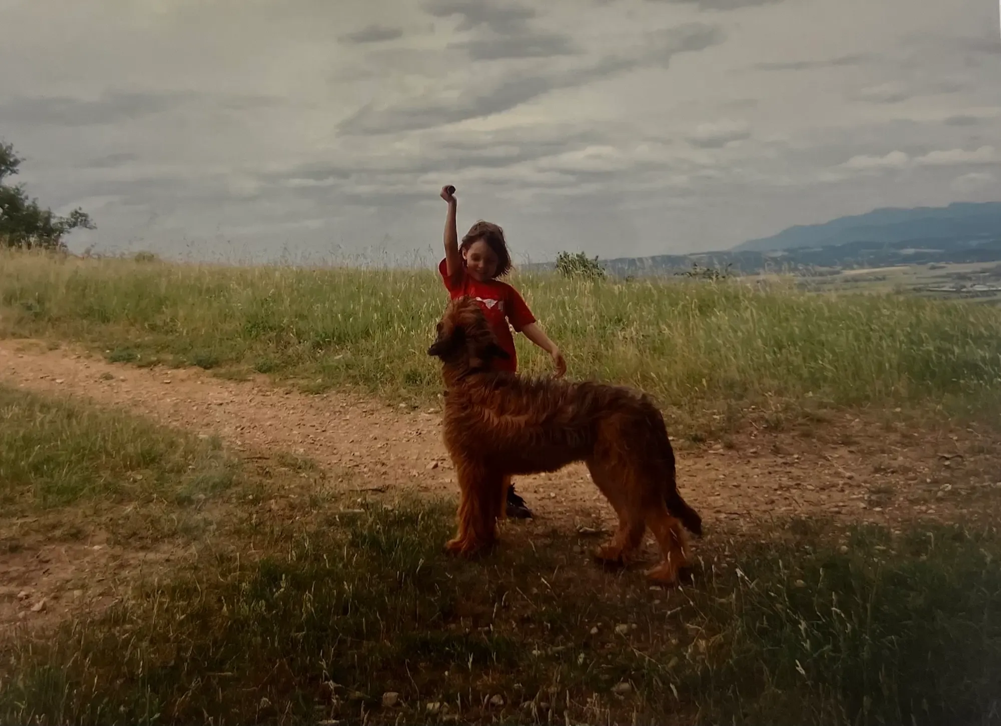 Emily playing with a dog outside